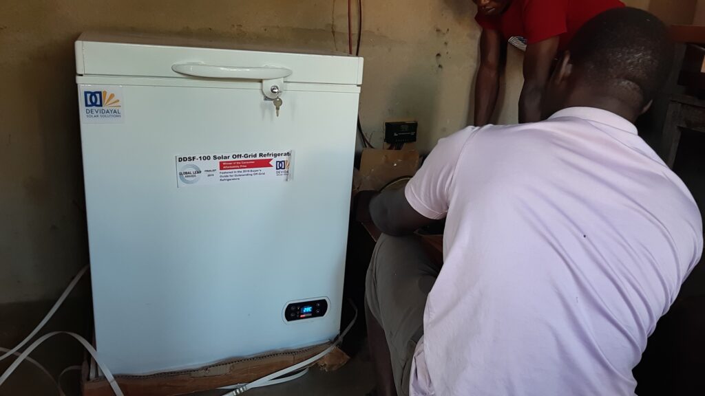DDSolar technician installing a solar refrigerator